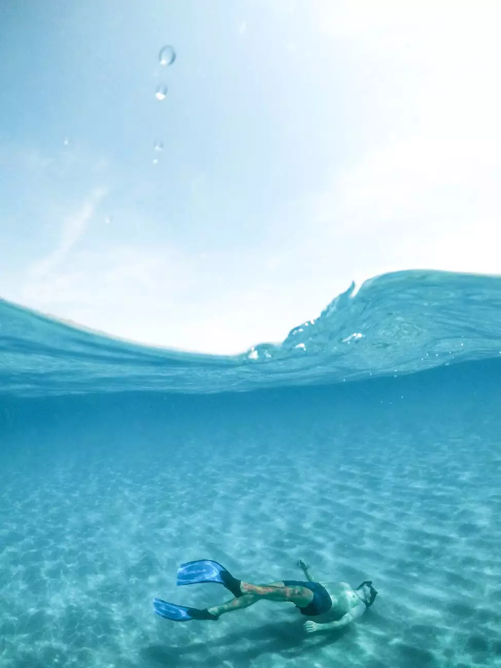 A snorkeler moving beneath clear ocean water